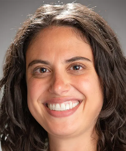 A woman with long hair smiles for the camera.