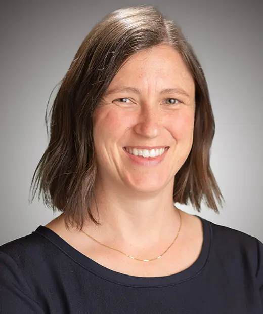 A woman with brown hair and wearing a black shirt.