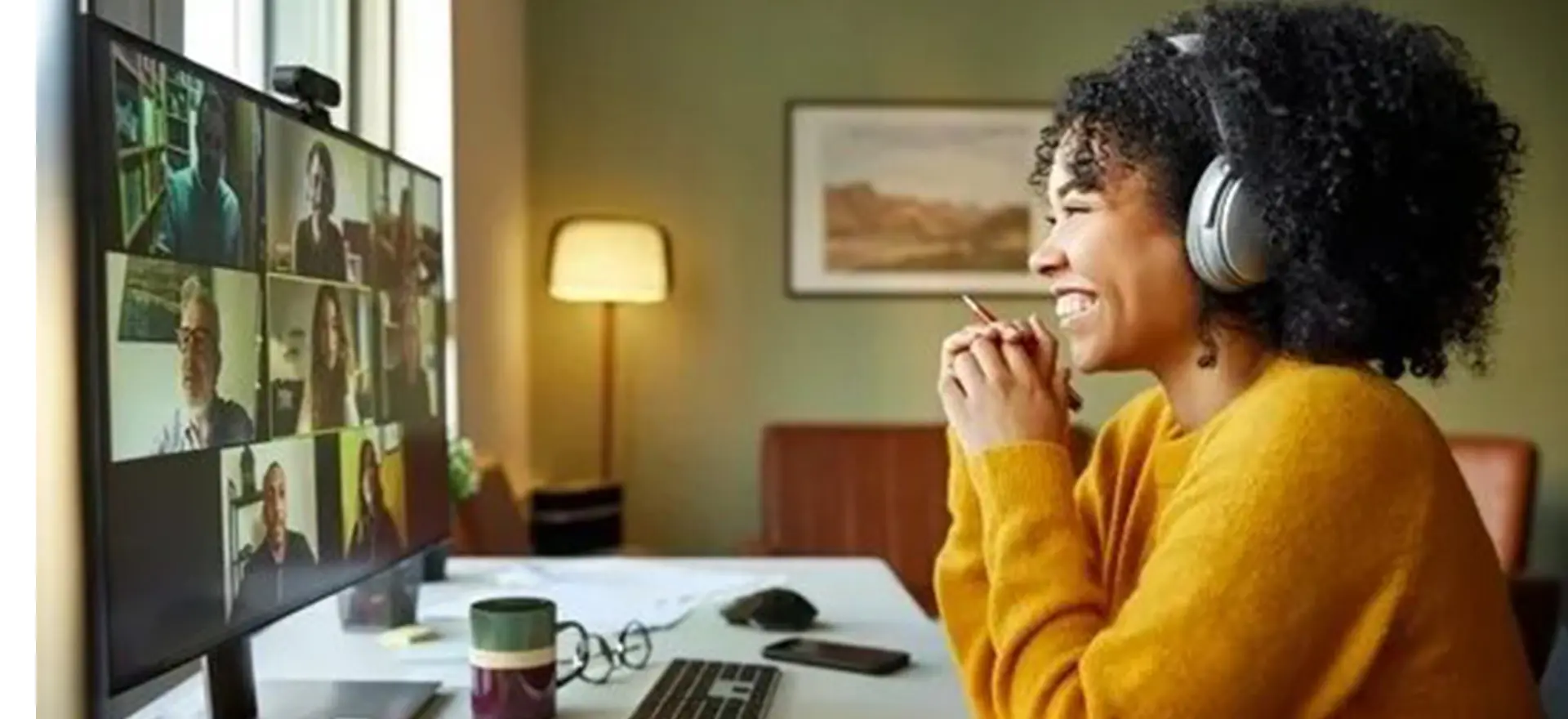 A woman sitting at a table with her hands under her chin.