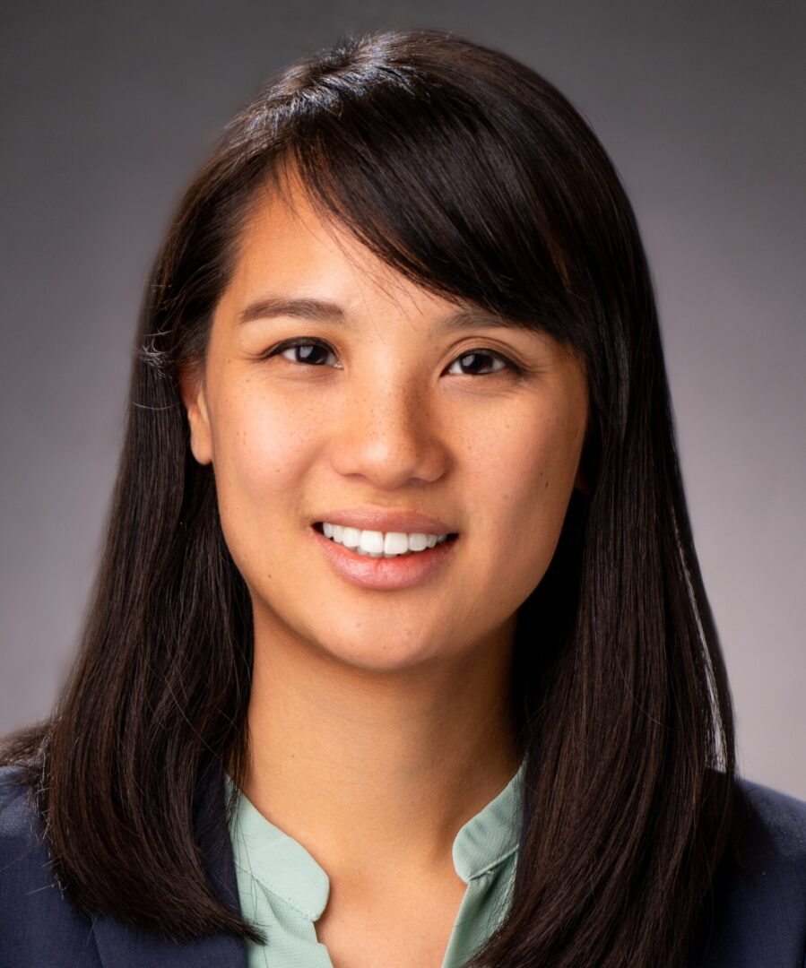 A woman with long hair and a blue shirt.